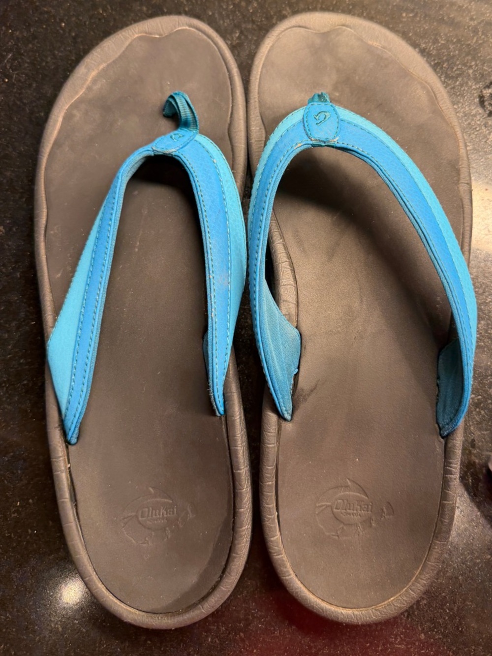 OluKai Women's Black Footbed Blue Strap Flip Flops